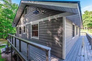 Terrace/patio - Dog-friendly, lakefront getaway w/ a wraparound balcony, beach, & boat access (Manitowish Waters)