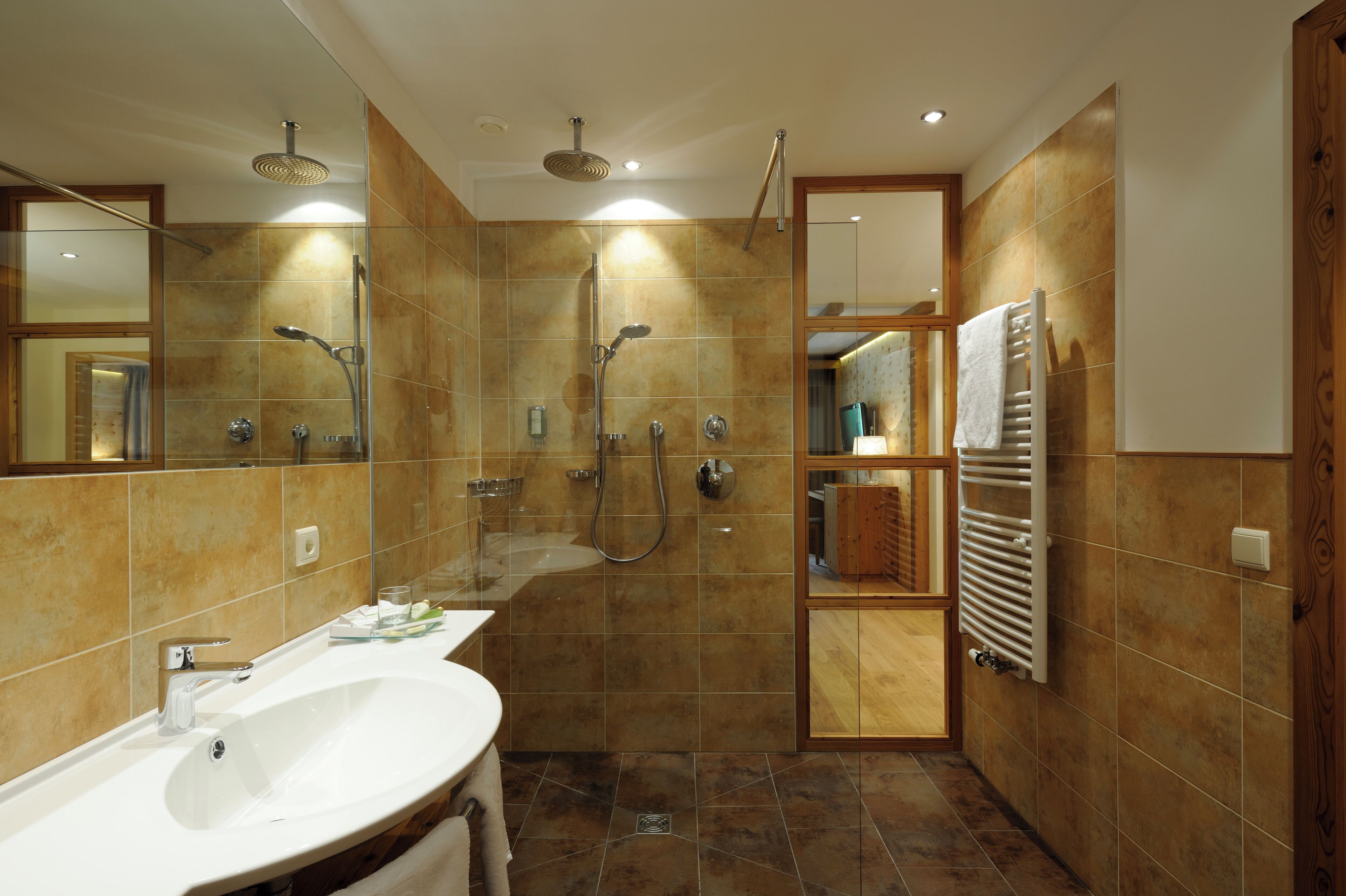 A modern bathroom with a bathtub, a shower, and a sink.