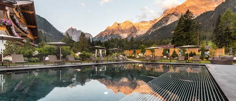A pool with a clear view of mountains in the background.