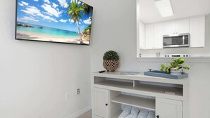 A modern kitchen with white cabinets, a microwave, and a built-in oven. - Under 1 Mile to Siesta Key Beach | Beach Gear Included | Pool | Sleeps 4 (Sarasota)