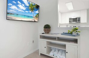 A modern kitchen with white cabinets, a microwave, and a built-in oven. - Under 1 Mile to Siesta Key Beach | Beach Gear Included | Pool | Sleeps 4 (Sarasota)
