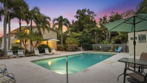 A swimming pool with lounge chairs, a table, and a covered area. - Under 1 Mile to Siesta Key Beach | Beach Gear Included | Pool | Sleeps 4 (Sarasota)