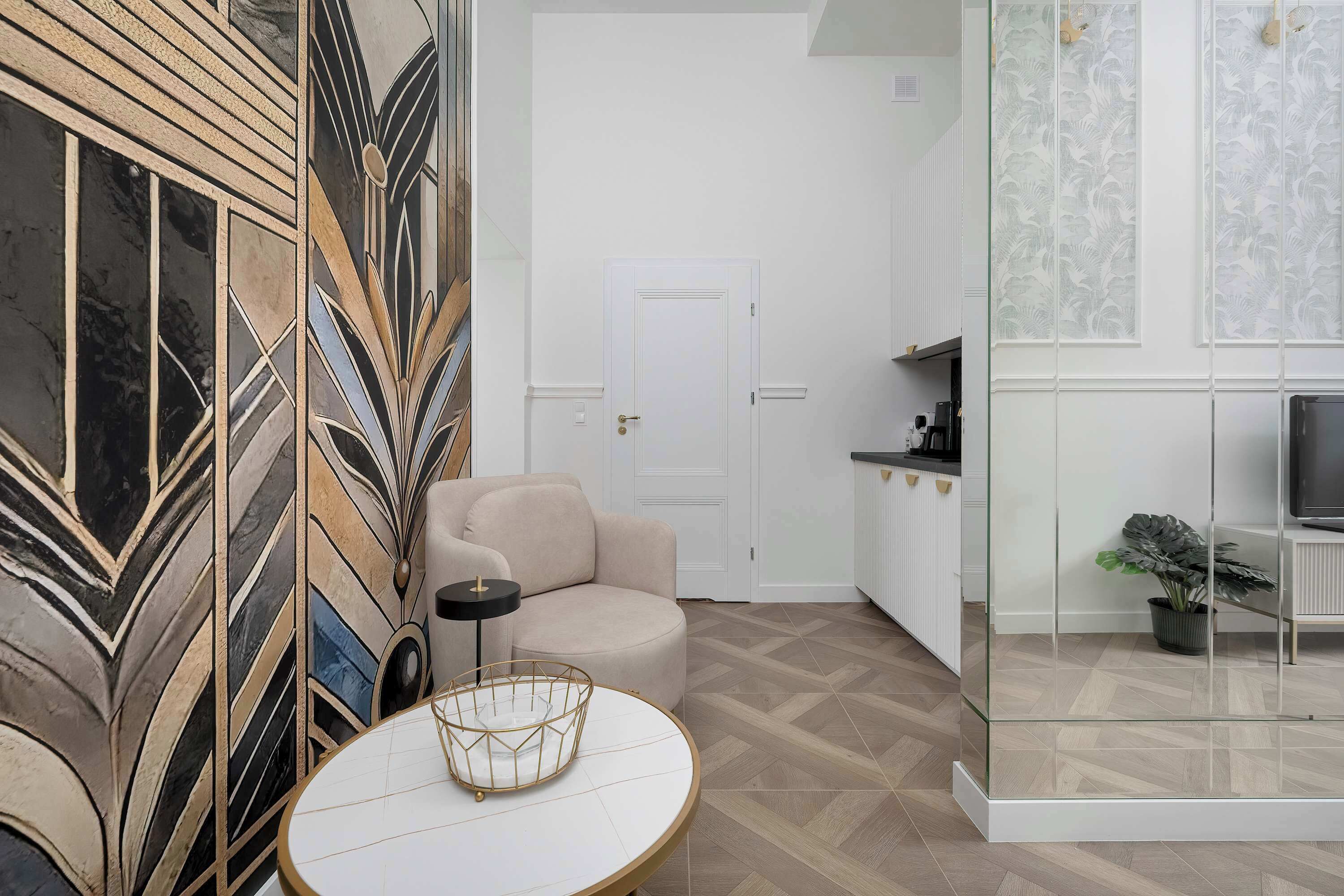 A modern living room with a sofa, a round table, and a decorative wall panel.