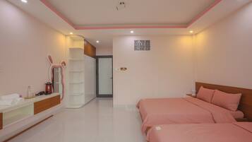 A bedroom with a bed, bedside table, and a mirror.