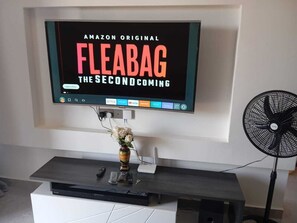 A flat-screen TV mounted on a wall displaying 'Amazon Original Fleabag The Second Coming.' - Senere 1BR Apartment next to a premier mall (Nairobi)