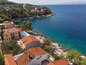 A coastal property with multiple buildings, a swimming pool, and a view of the sea. - Beachfront Villa Dream with pool by Interhome (Blato)
