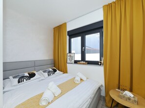 A hotel room with a bed, a window, and a small table with a tissue box. - Villa Good Vibes with heated pool by Interhome (Vrsi)
