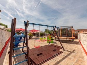 A playground with a swing set, slide, and climbing area. - Villa Ancora for 16 guests,  No.1 by Interhome (Donje Rastane)