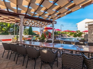 An outdoor patio with a pool, covered seating area, and a view of the surrounding buildings. - Villa Ancora for 16 guests,  No.1 by Interhome (Donje Rastane)
