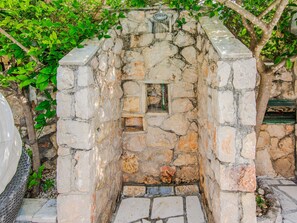A stone-built structure with a small window and a water feature. - Vacation home  by Interhome (Rovanjska)