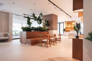 A modern interior with a seating area, a wooden partition, and a view of the outdoors. - Majestic 2-Bed Balcony City View Loft Suite by Bocobay (Willemstad)