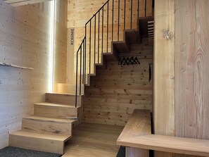 A wooden staircase with a metal railing and a nameplate reading 'ROBINIE'. - Ferienhaus Regan, Obersaxen-Valata, (Surcuolm), 38044B by Interhome (Surcuolm (Obersaxen))