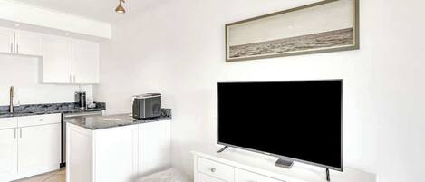 Unwind in your bright, modern space with a full kitchen and cozy living area perfect for streaming your favorite shows.