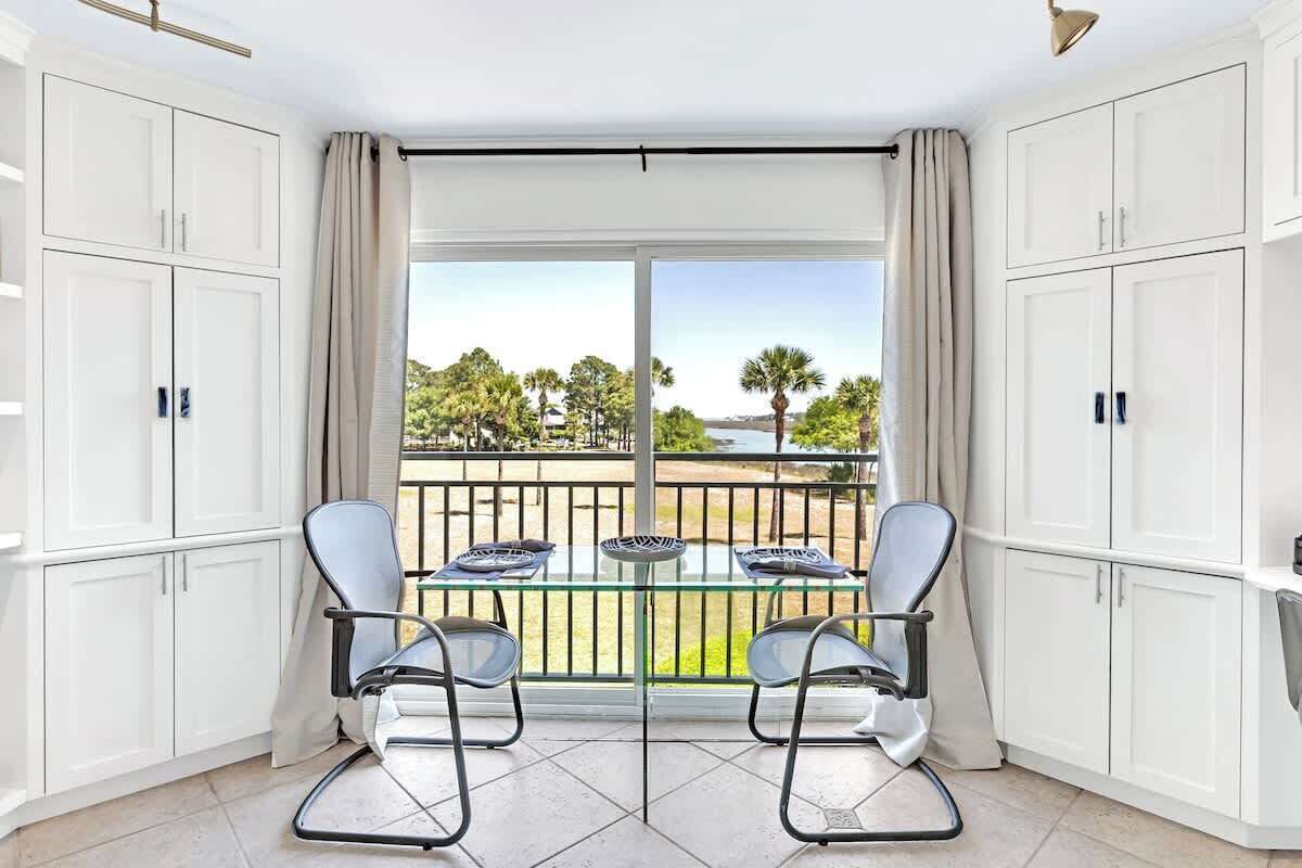 Your bright dining space opens to a serene water view, where morning coffee tastes better with palm trees swaying outside your window.
