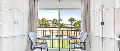 Your bright dining space opens to a serene water view, where morning coffee tastes better with palm trees swaying outside your window.