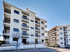 A multi-story residential building with balconies, a gated entrance, and a parking area. - Apartment  by Interhome (Albufeira)