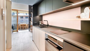A modern kitchen with a built-in oven, a sink, and a countertop. - Studio La Montanara in Brand (Brand)