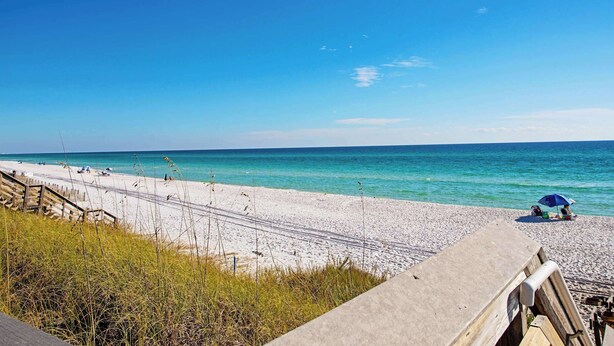 A beach with a wooden walkway, a sandy shore, and a clear blue sky. - Yew 2!- House + Carriage House- Steps to Beach! (Santa Rosa Beach)
