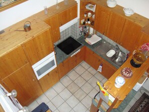 Fridge, microwave, oven, cookware/dishes/utensils - Wohnung Baltensperger, (Andeer). by Interhome (Andeer)