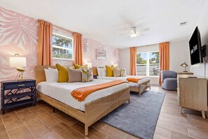 A bedroom with a bed, bedside tables, a desk, a chair, a TV, and a ceiling fan. - Sleeps 10 | Pickleball | Pool | Tiki Bar | Games (Bradenton)