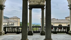Une cour intérieure ornée de colonnes classiques, avec en arrière-plan une vue sur des bâtiments.