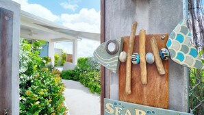 A wooden sign with the word 'SEAROCK' and a decorative arrow pointing to the right. - SeaRock – Elegant Villa with Private Pool and Tropical Garden at Le Diamant (LE DIAMANT)