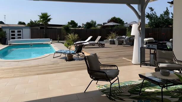A covered outdoor area with a pool, lounge chairs, and a barbecue grill. - 5-Room Villa with Pool and Terrace in Le Porge (Le Porge)