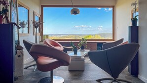 A modern dining area with a large window, a ceiling-mounted light, and a view of a landscape. - Family property in a green setting - 9 to 10 people (Nébian)