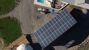 A property with multiple spherical structures, a swimming pool, and solar panels.
