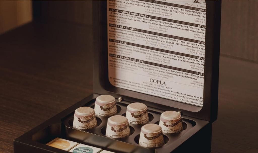 A menu in a box with coffee cups.