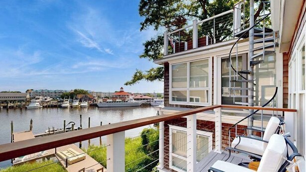 A waterfront property with a balcony, outdoor seating, and a view of the marina. - Town of Lewes condo steps from the park w/Tennis, Pickleball & Basketball (Lewes)