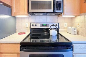 Fridge, microwave, oven, stovetop - 2nd-floor Sunspot condo steps from beach with balcony, outdoor shower, W/D, & AC (Dewey Beach)
