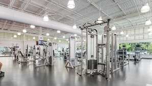 A spacious gym with various exercise machines, large windows, and a high ceiling. - Sea Colony 7th floor condo with ocean veiw, pool, basketball court &  gym (Bethany Beach)