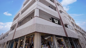A multi-story hotel with a modern architectural design, featuring a prominent 'HOTEL' sign on the facade. - Saver Double Royapettah Clock Tower RKH (Chennai)
