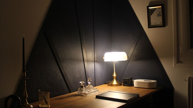 A desk with a lamp, a framed certificate, and a speaker. - Le Repaire du Gentleman - Spa, Private Cinema & King-Size Bed • Enclosed Garage (Étretat)