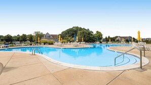 A swimming pool with multiple lanes, lounge chairs, and umbrellas. - 2nd-floor condo at Bethany Bay with pool, on-site golf, and sports courts (Ocean View)