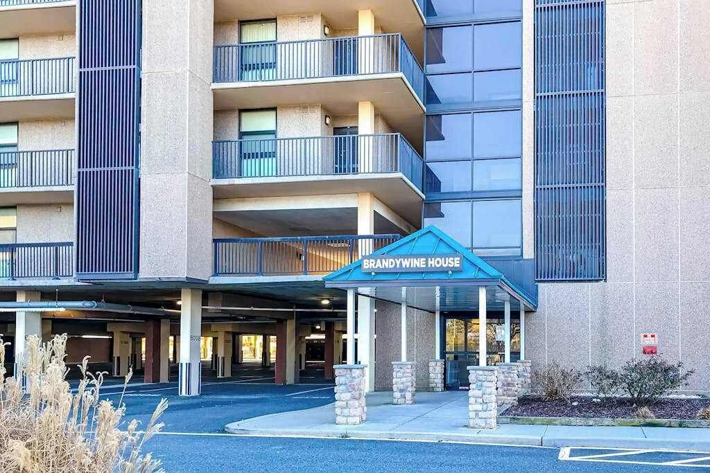 A multi-story hotel with a covered entrance labeled 'BRANDYWINE HOUSE.'