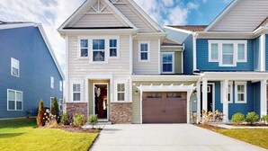 A two-story residential building with a garage, a covered entryway, and a well-maintained lawn. - Bishop's Landing townhouse with grill, outdoor pool, gym, tennis court, shuttle (Millville)