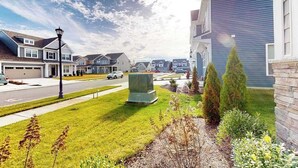 A residential street with houses, a street lamp, and a central air conditioning unit. - Bishop's Landing townhouse with grill, outdoor pool, gym, tennis court, shuttle (Millville)