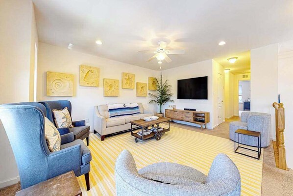 A living room with a sofa, armchairs, a coffee table, and artwork on the walls. - Bishops Landing townhome with private washer/dryer, shared pool, tennis, gym (Millville)