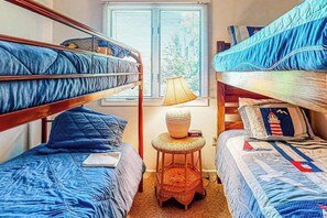A dormitory room with bunk beds, a small stool, a lamp, and a window with blinds. - Bayberry Woods townhouse with access to pool/tennis, fireplace & washer/dryer (Bethany Beach)