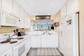 Fridge, microwave, oven, stovetop - Bethany Bay second floor condo with pool, high-speed WiFi, central AC, & W/D (Ocean View)