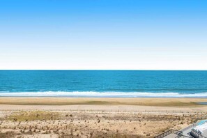 A beach view with a sandy shore and a clear blue sky. - Sea Colony Ocean Seventh Floor Condo with Shared Pool, Ocean View, and WiFi (Bethany Beach)