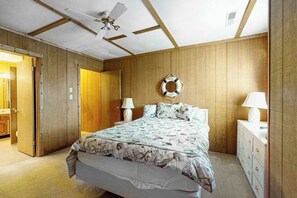 A bedroom with a bed, bedside lamps, a ceiling fan, and a life ring on the wall. - Mallard Lakes Home w/Beautiful Water Views From Screened-In Porch, Shared Pool, WD (Selbyville)