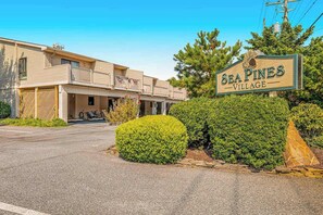 A two-story building with a sign reading 'Sea Pines Village.' - Sea Pines Townhouse Steps From the Water w/Free WiFi, Shared Pool, Private W/D, AC (Bethany Beach)