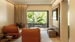 A modern living room with a sofa, coffee table, and a TV.