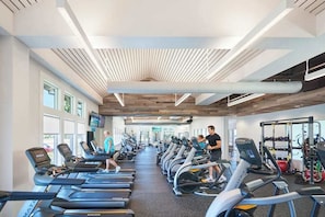 A gym with treadmills, stationary bikes, and weight machines.