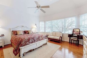 A bedroom with a bed, a vanity, a chair, a desk, and a ceiling fan. - Bethany Lakes home with waterfront views, pool access, tennis, & private patio (Bethany Beach)