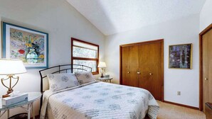 A bedroom with a bed, a window, a door, and a painting on the wall. - Secluded, 4-BR, dog-friendly home, private beach (Bethany Beach)