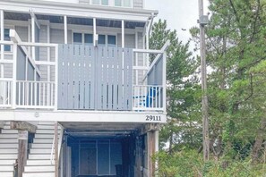A two-story building with a balcony, a visible number '29111', and a staircase leading to the entrance. - Atlantic Watergate townhome steps from the beach, oceanfront balconies (Bethany Beach)
